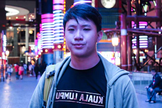 A dynamic influencer engaging with a vibrant urban backdrop under neon orange lights.