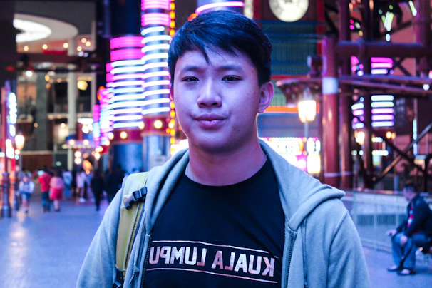 A dynamic influencer engaging with a vibrant urban backdrop under neon orange lights.