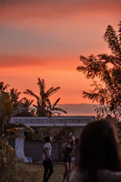 Sunset view over the lush garden area with guests enjoying the evening.