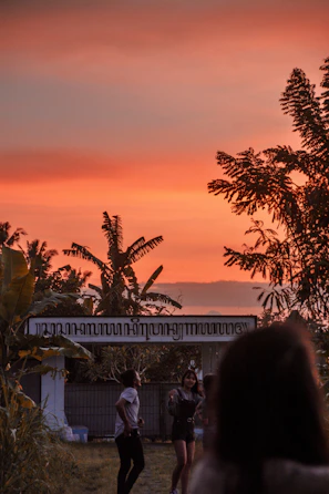 Sunset view over the lush garden area with guests enjoying the evening.