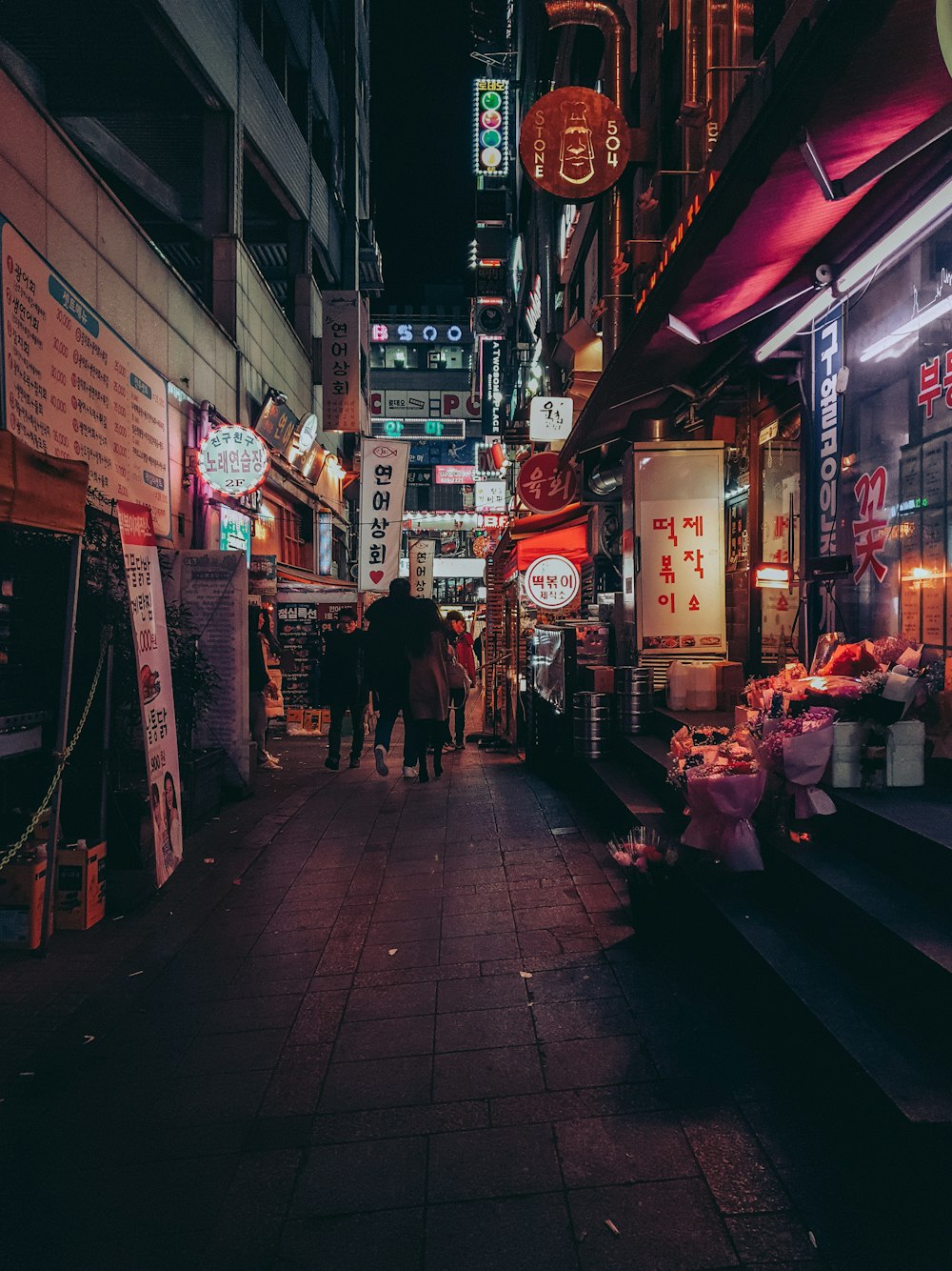 people walking between buildings