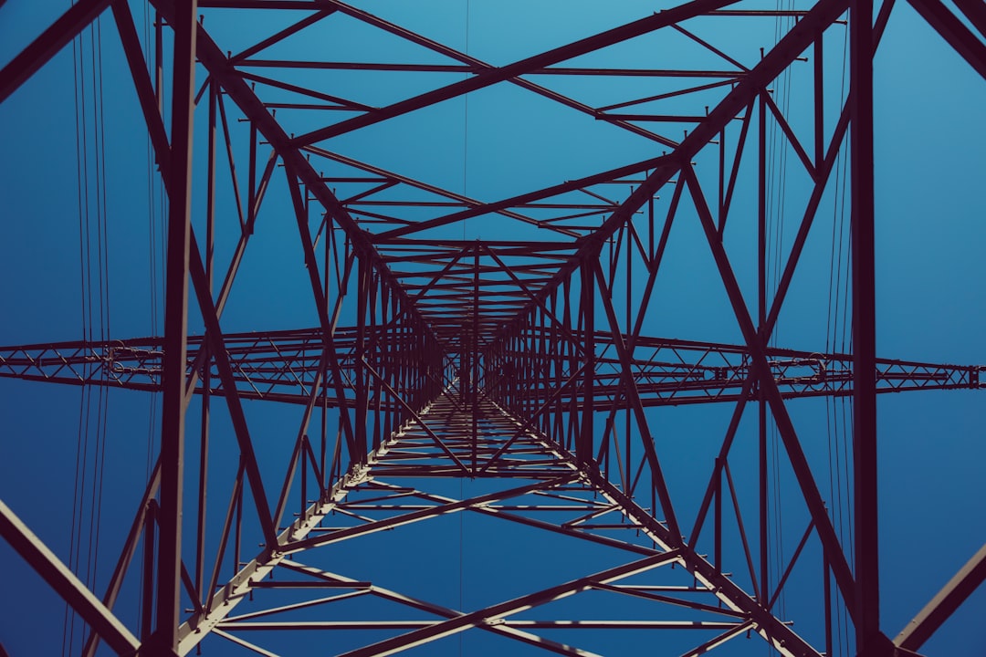 low angle photography of black transmission tower