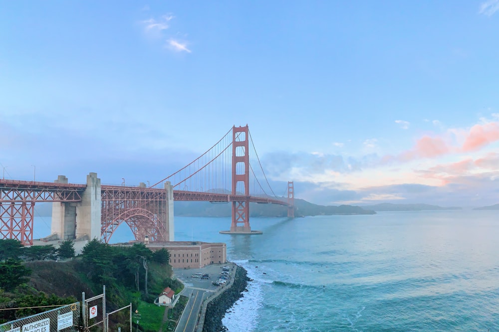 red metal bridge over body of water