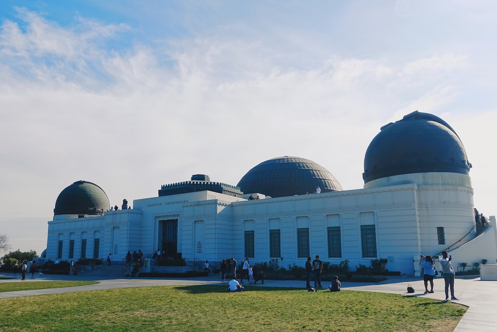 people walking near black and white dome building