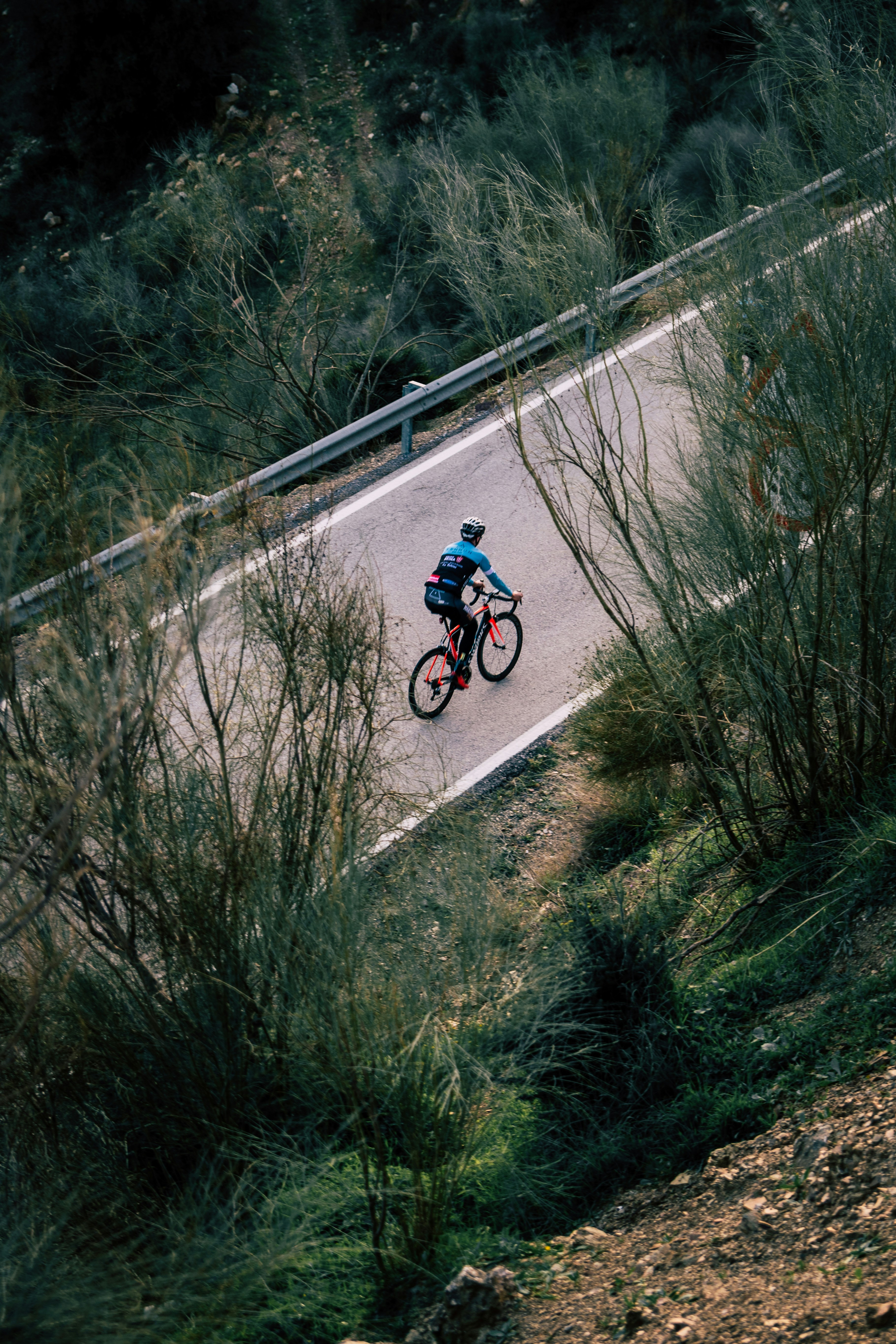 man cycling on empty road
