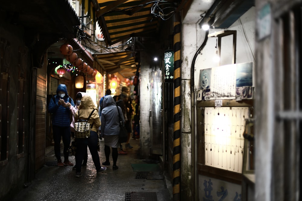 people walking on narrow pathway