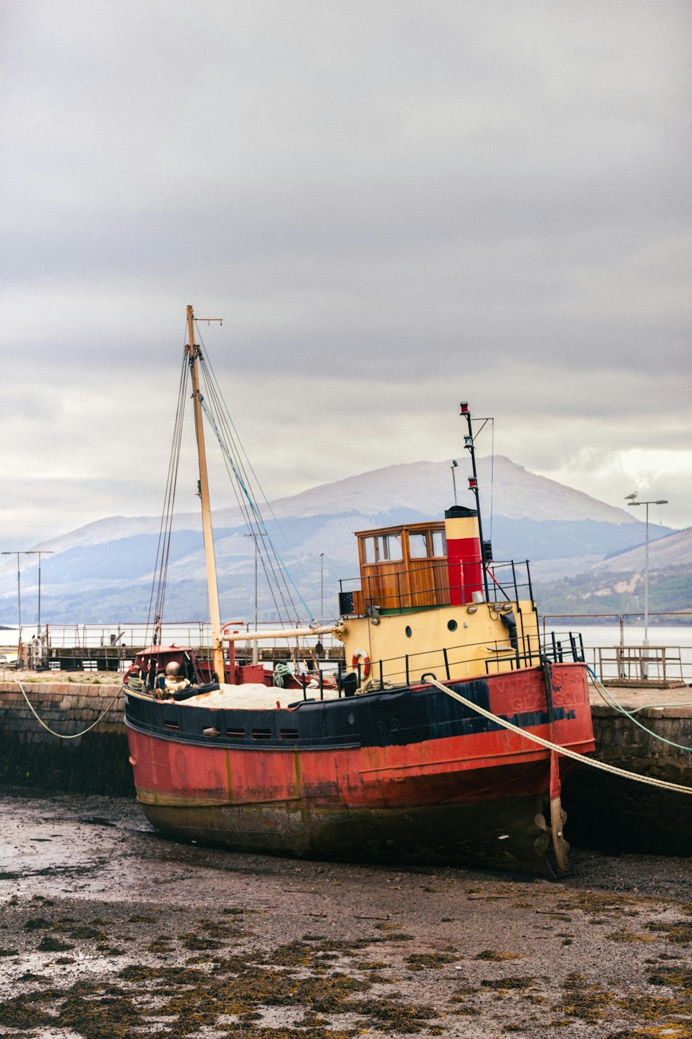 red and black boat near dock viewing mountain