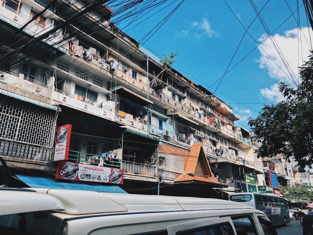 vehicle running on road beside building during daytime