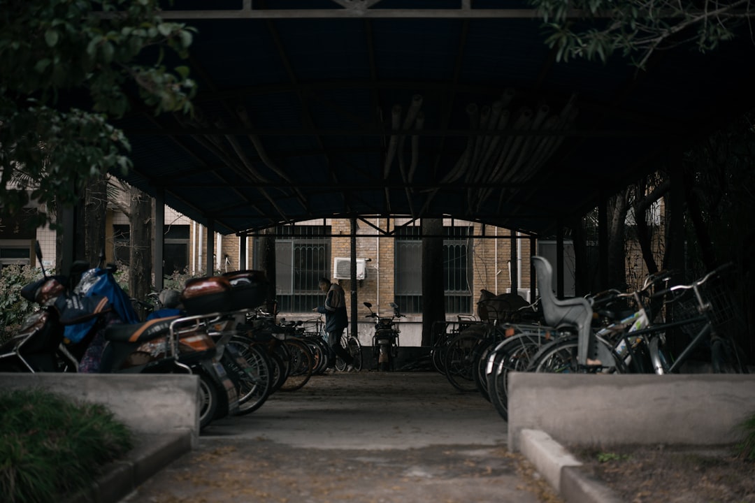 motorcycles and bicycles on park under roof during daytime
