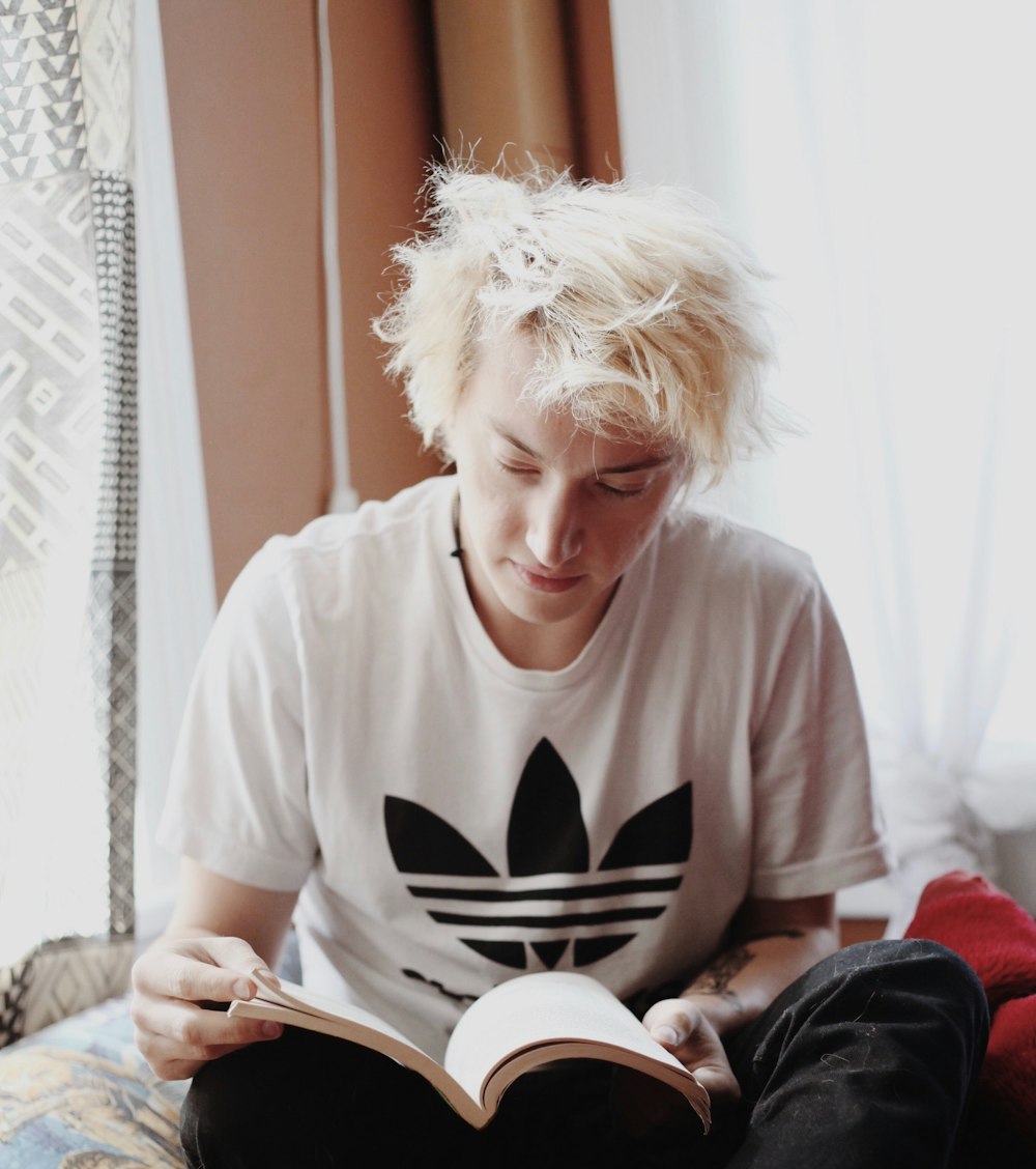 man reading book while sitting