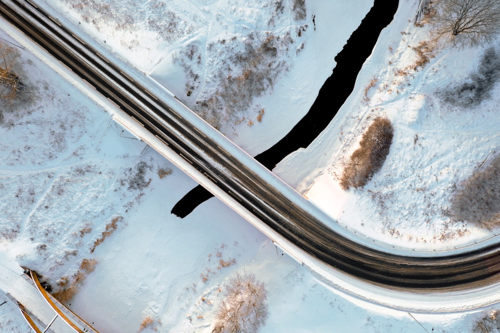 an aerial view of a road in the snow