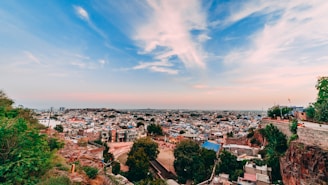 panoramic photography of houses and buildings under blue and white sky during daytime