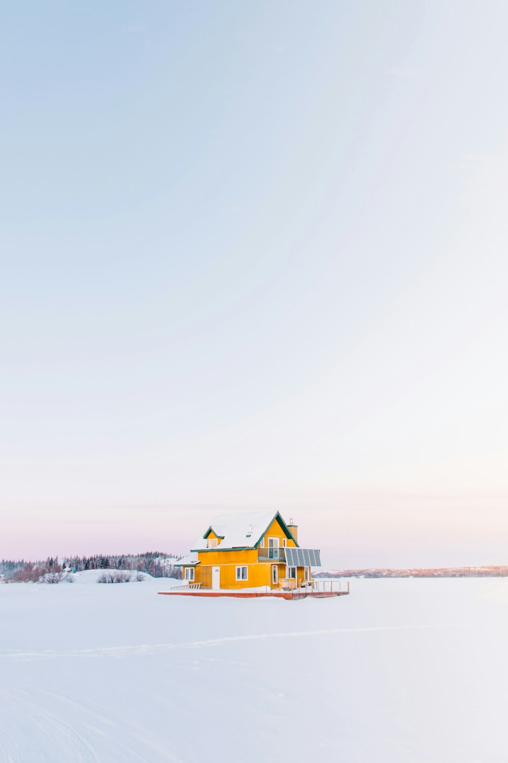 yellow cabin on snow field