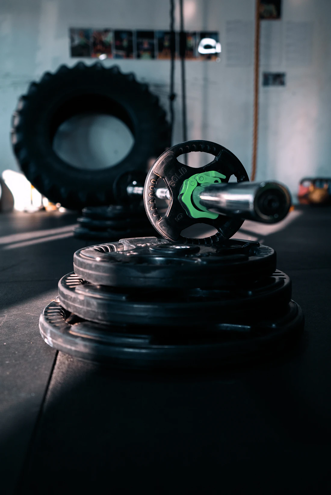 Loaded plates and a barbell on the gym floor