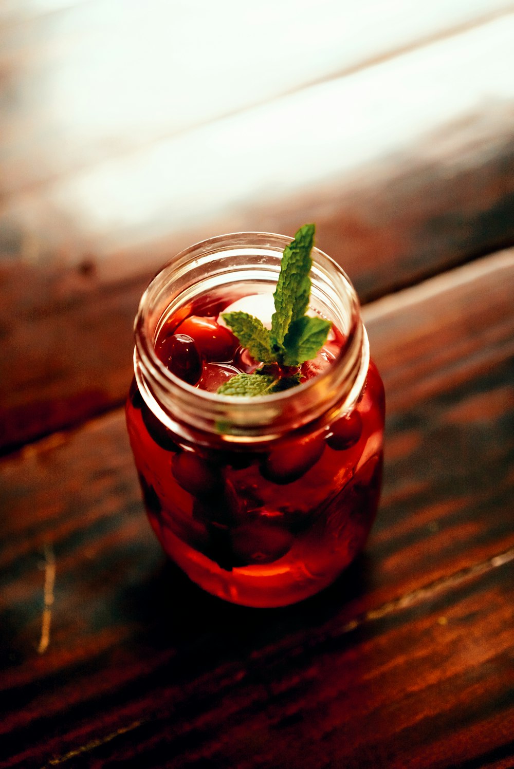 clear glass bottle with green leaf