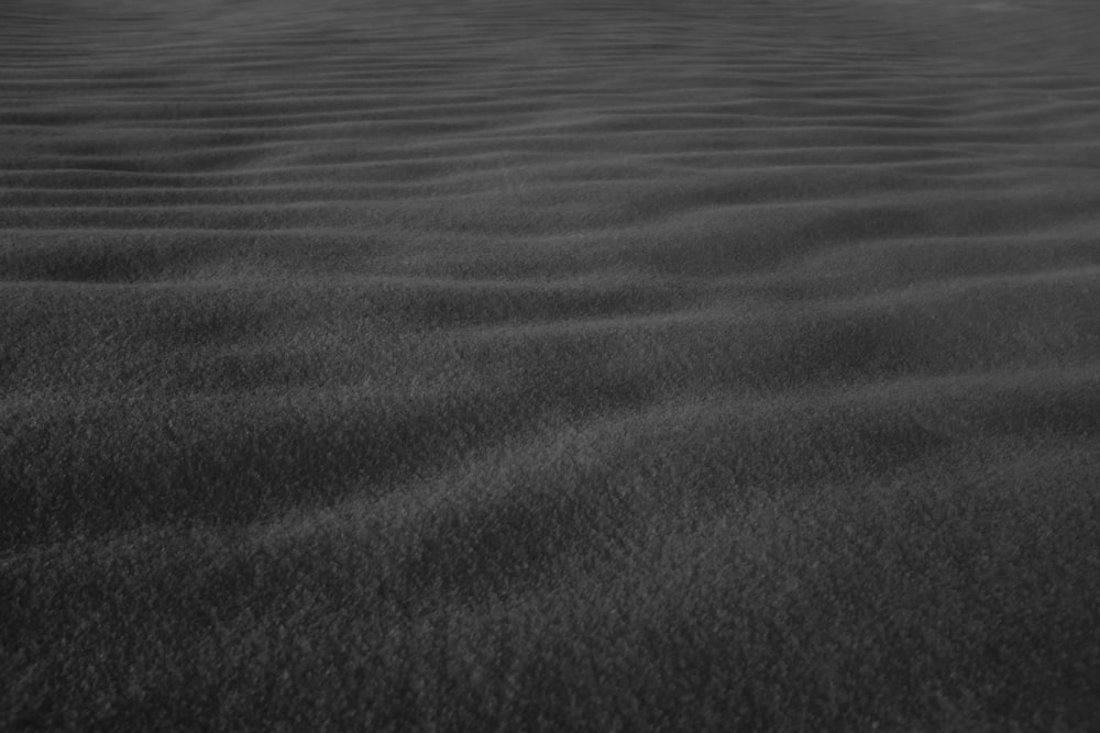 a black and white photo of sand dunes