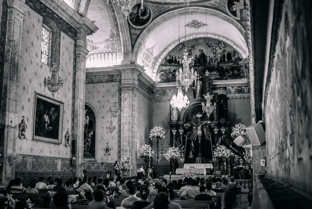 a black and white photo of a church filled with people