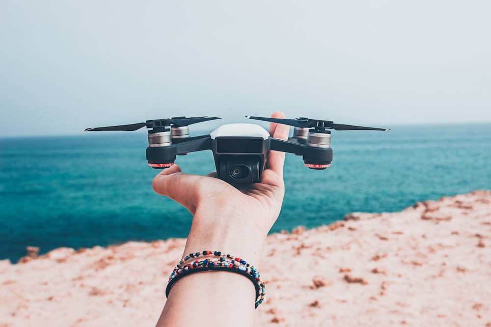 white and black quadcopter drone