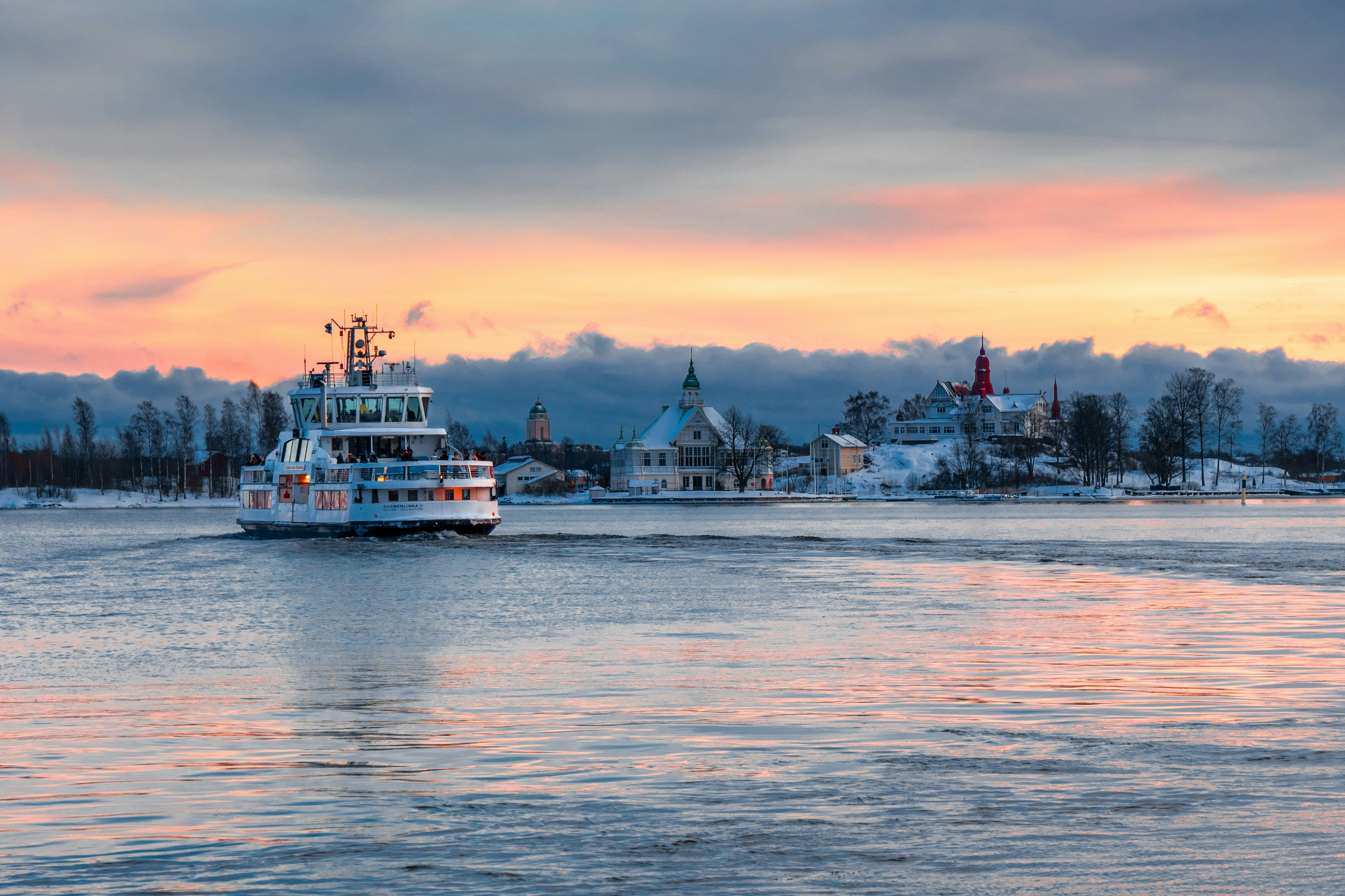 Ferry to Suomenlinna Sea Fortress Takes Off from Helsinki Market Square in Beautiful Winter Sunset.