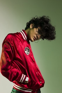 Close-up of a man showing off a geek style jacket with vibrant colors.