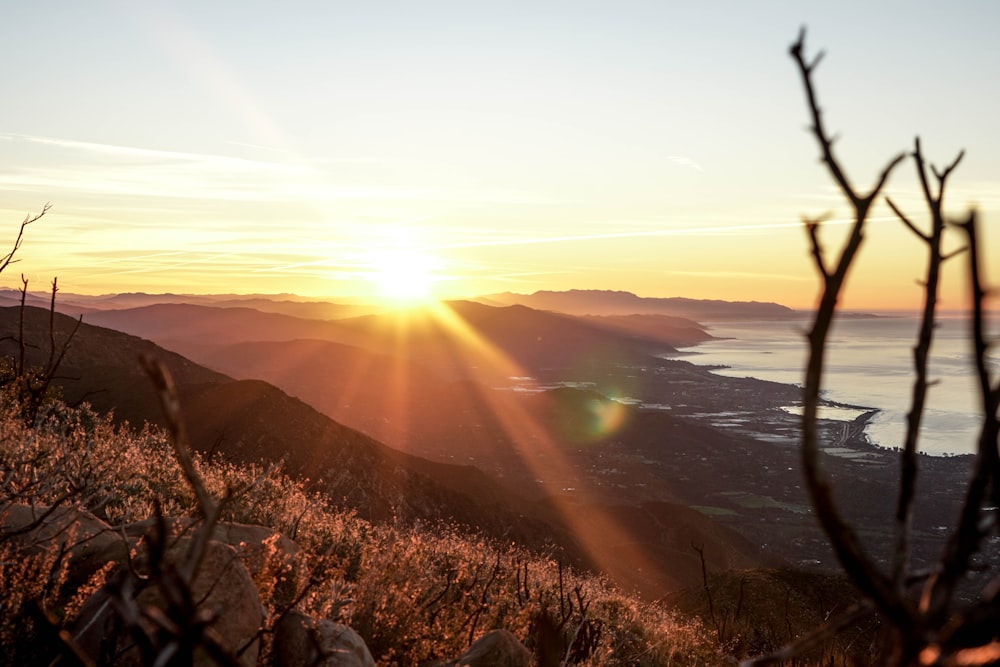 mountain near sea during golden hour