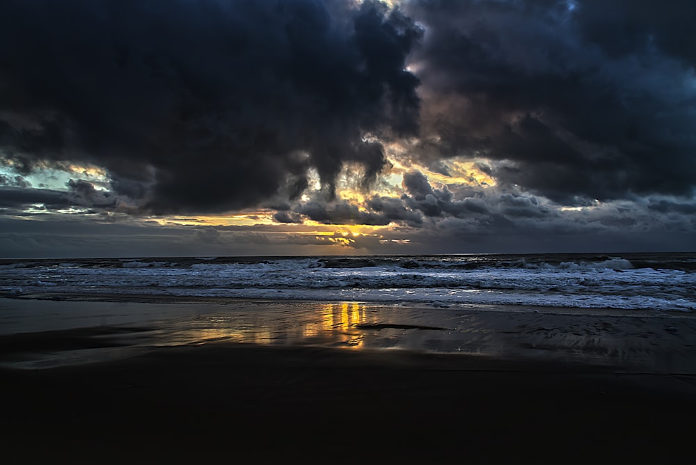 wavy ocean under gray clouds