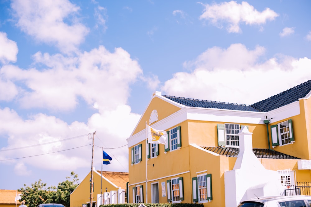 yellow and white house under blue and white sky