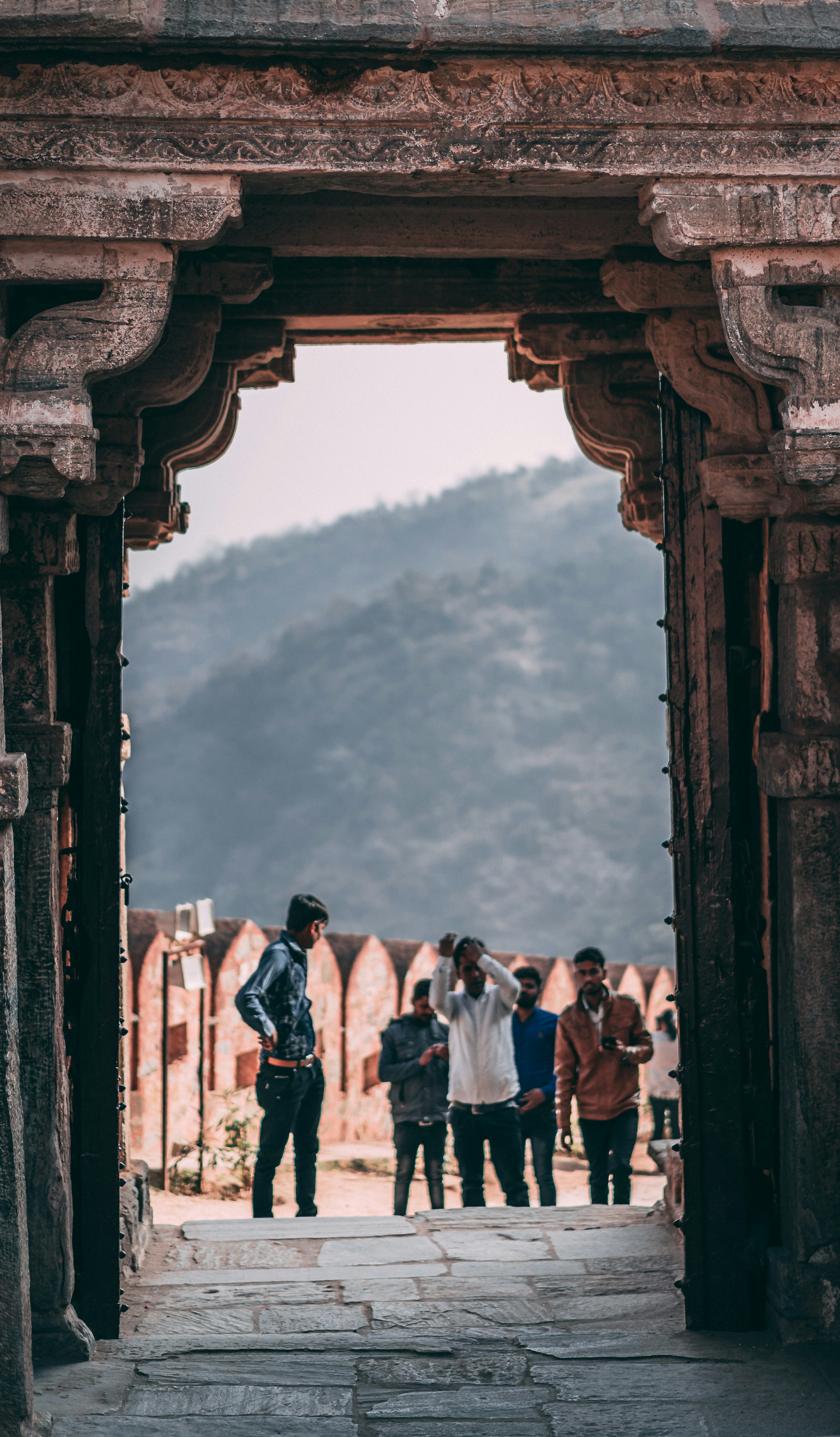 people walking through tunnel gate
