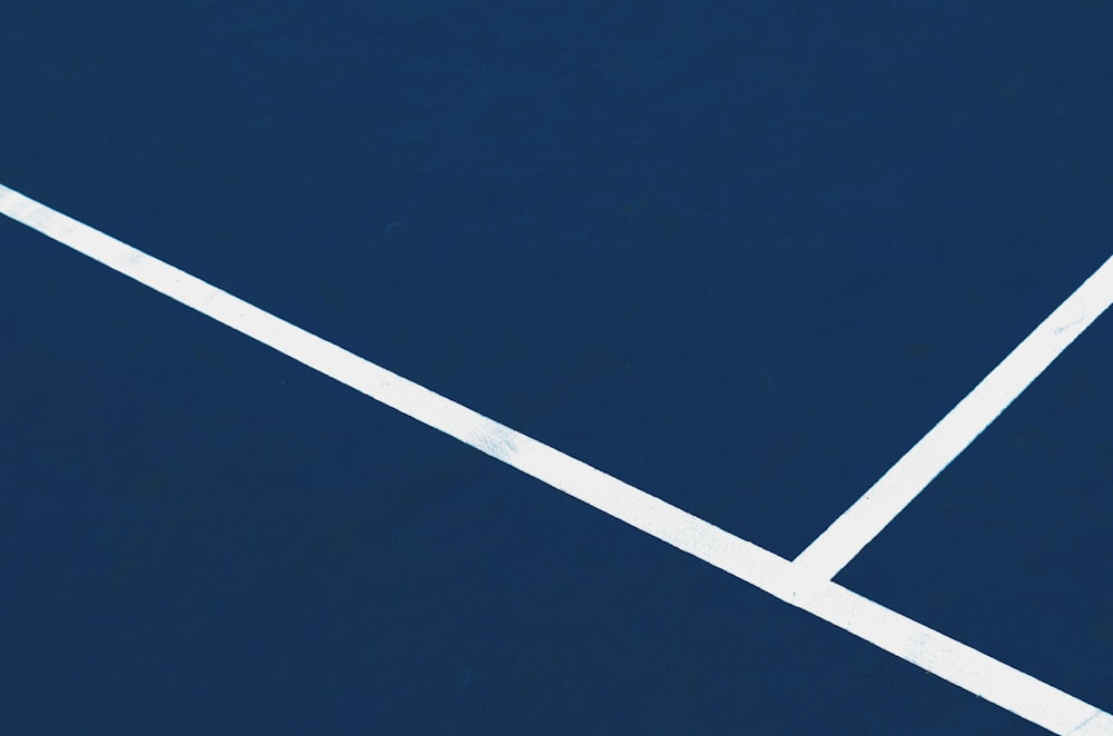 a blue tennis court with a white line on it