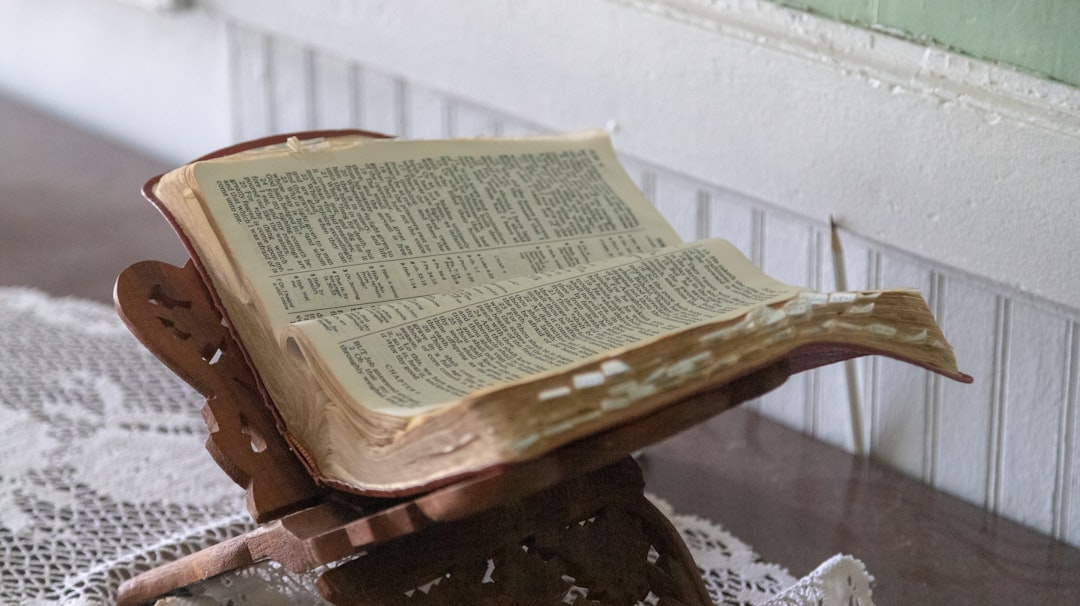 opened Bible on brown wooden stand