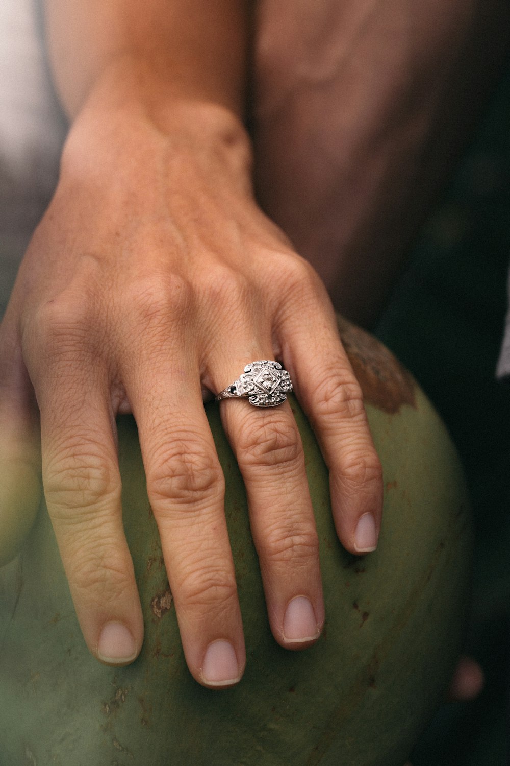 person wearing silver diamond ring