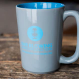 Custom merchandise items including mugs and t-shirts with printed logos.