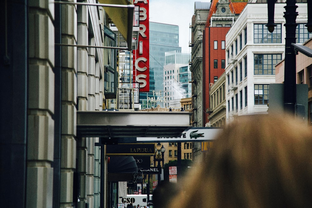 people walking inline of high-rise buildings