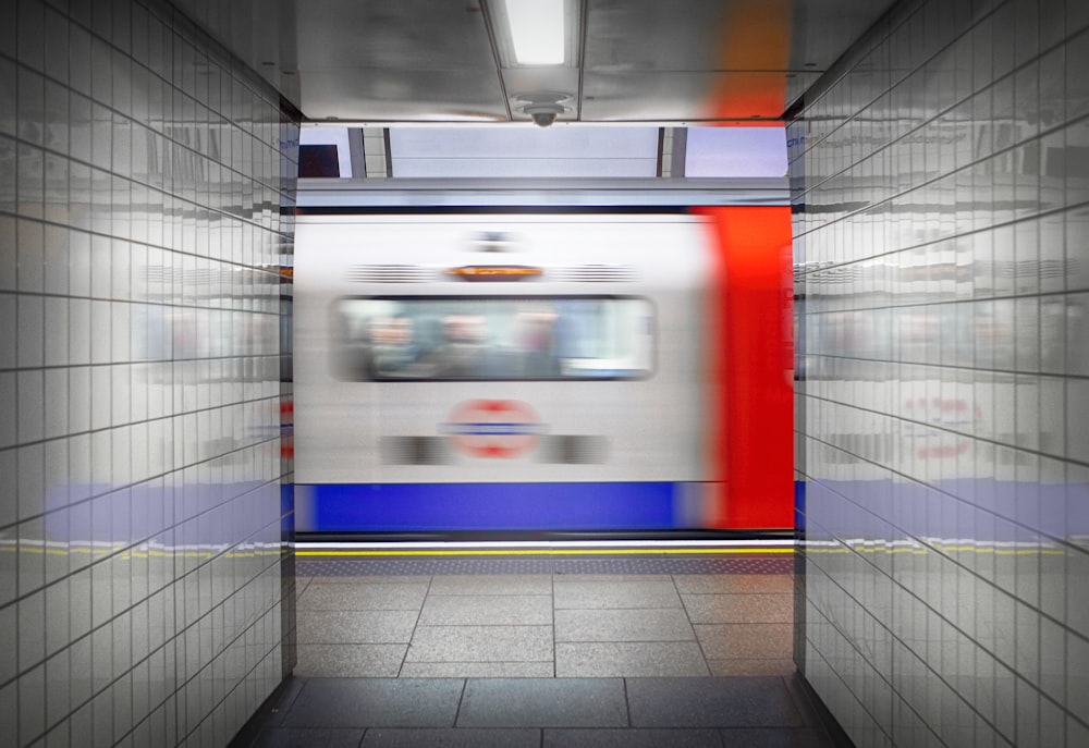 a subway train passing through a subway station