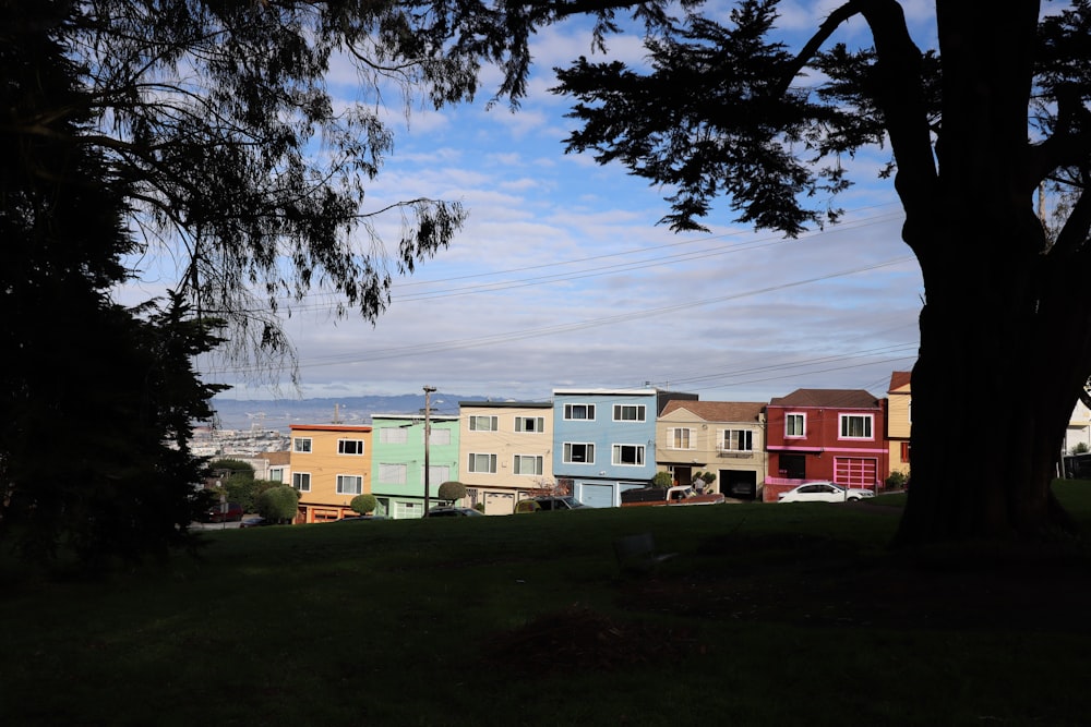 assorted-color concrete buildings near trees during daytime