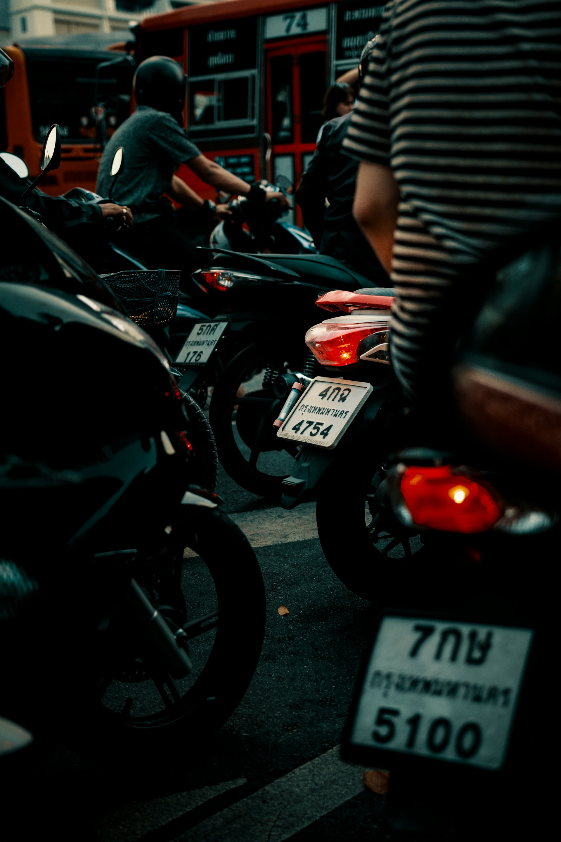 man in black T-shirt rides motorcycle on road