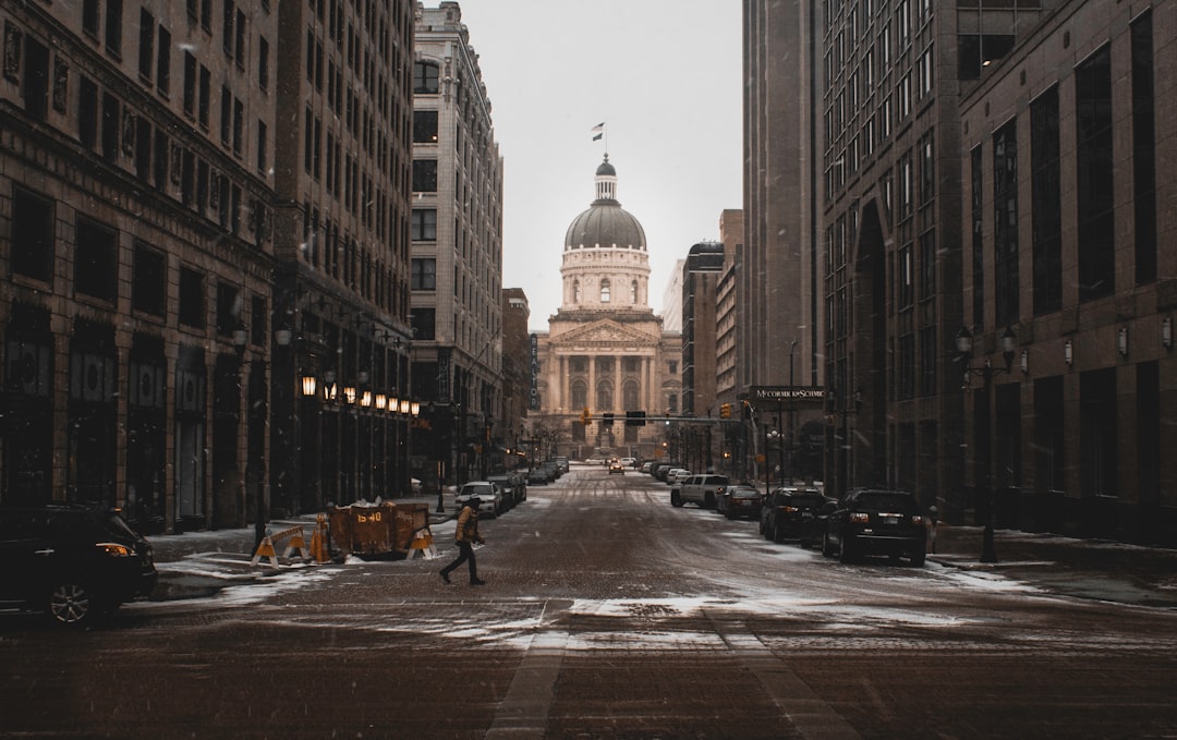 person walking on street between buildings