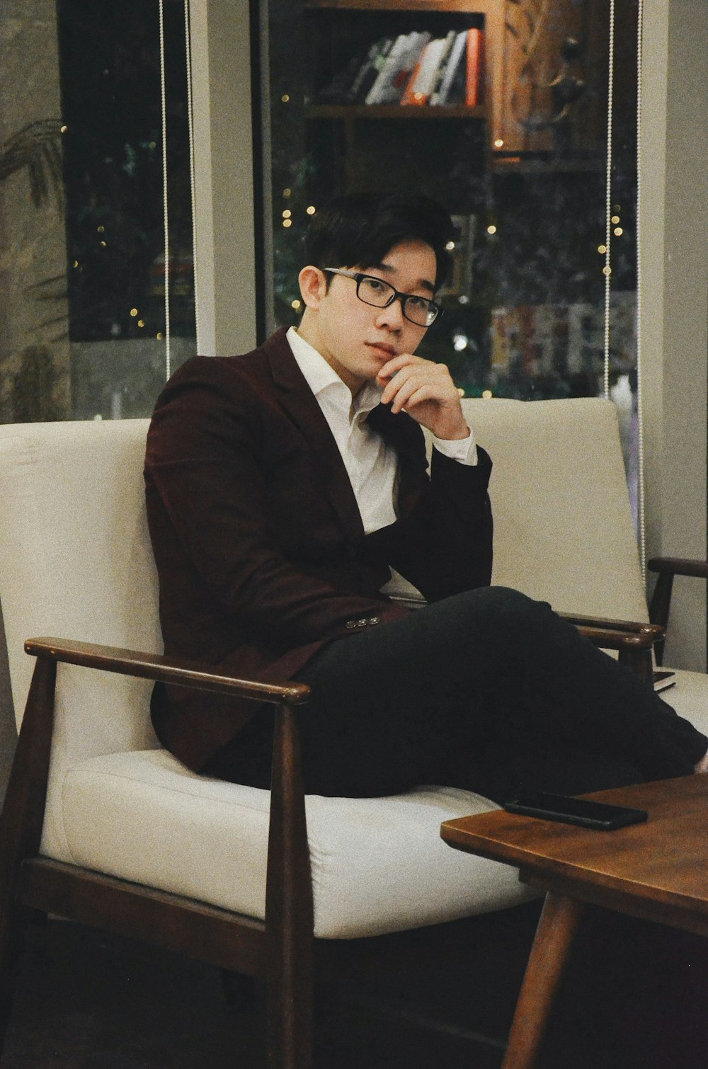 man sitting on sofa chair near table