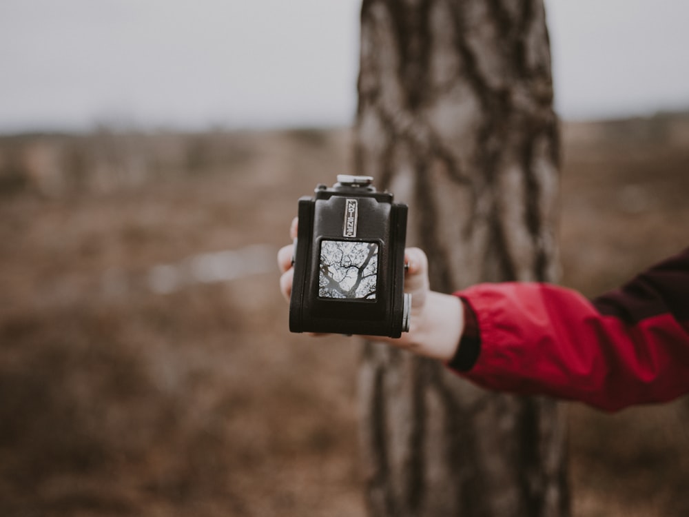 person holding black and gray case