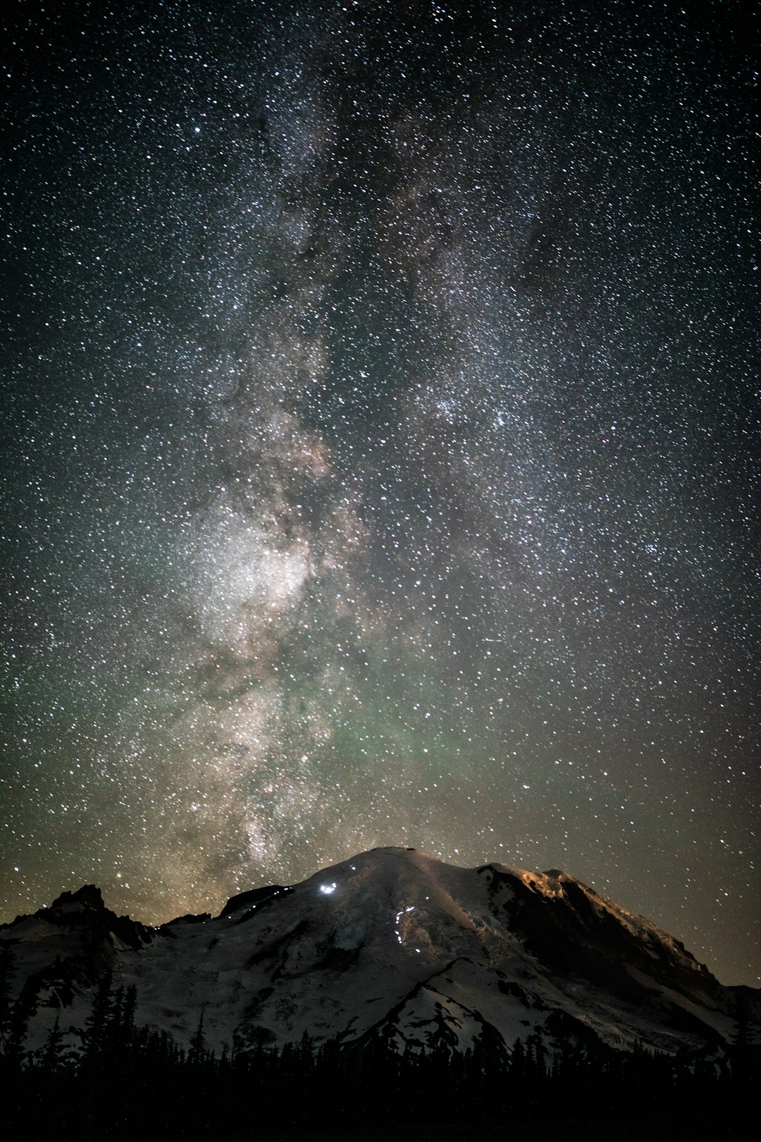 snow covered mountain under stars during night time