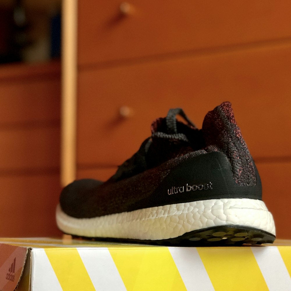 black Adidas Ultra Boost shoe on box