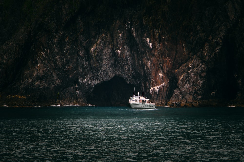 white yacht near mountain