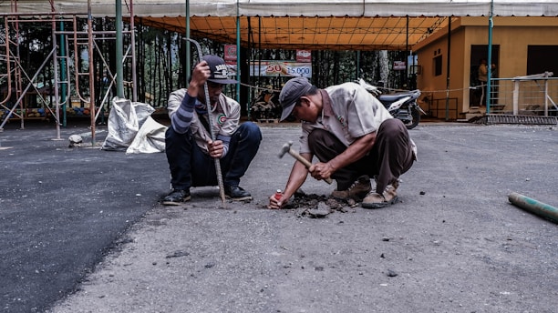 two men fixing the road