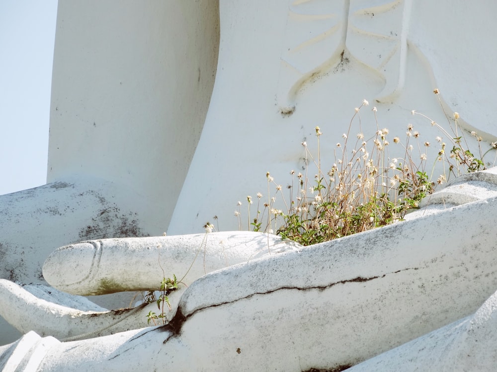 white concrete hands statue