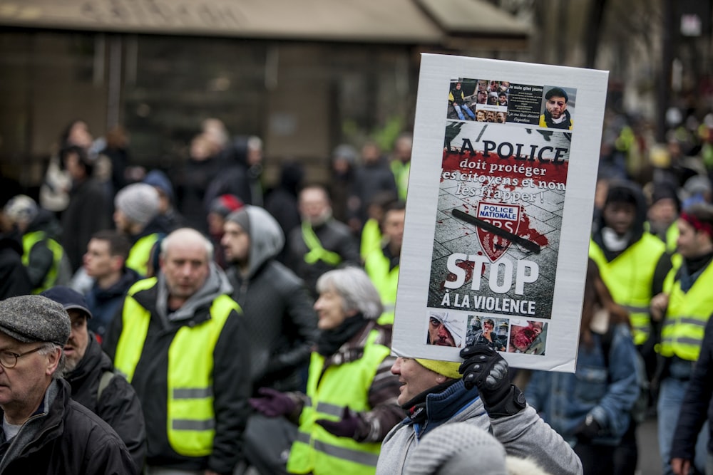 people gathering wearing green vest