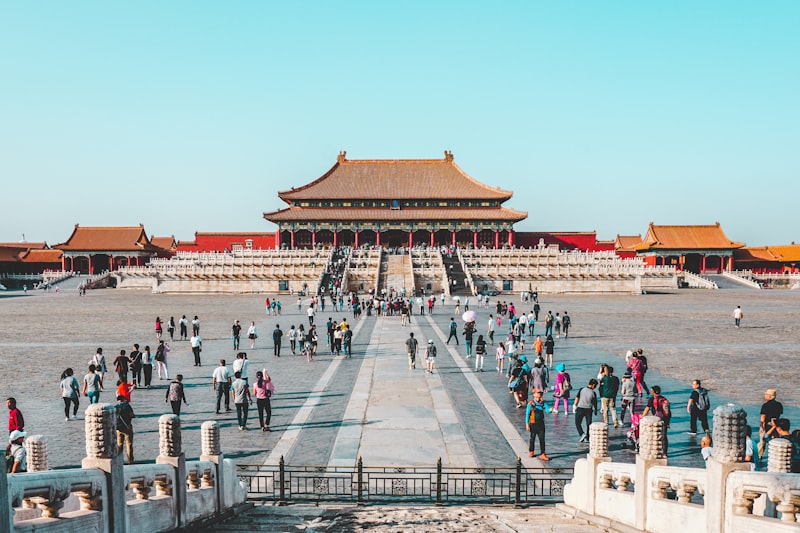 budget travel students walking Beijing hutong happy group