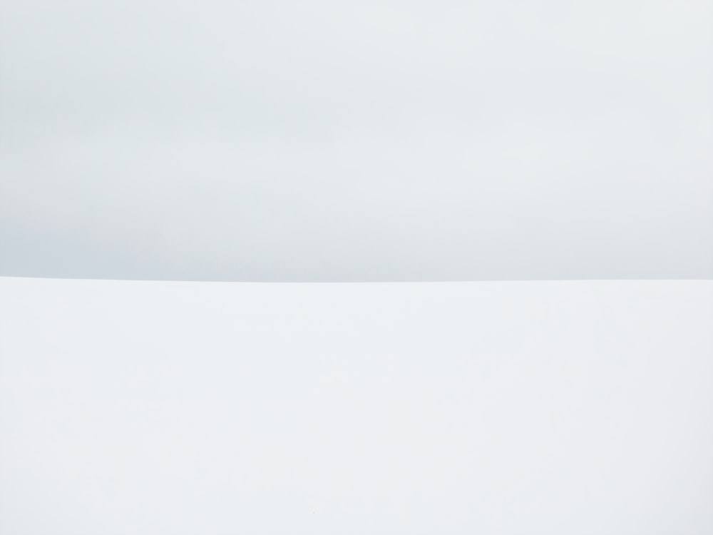 a man riding skis on top of a snow covered slope