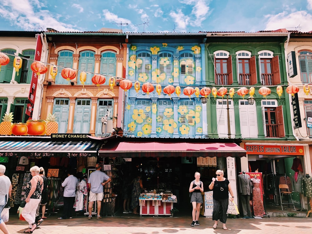 people at multicolored painted store during daytie