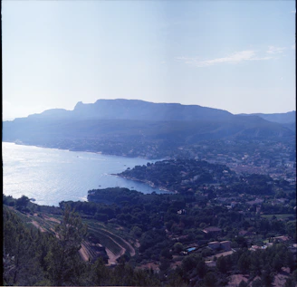 A sweeping coastal view of the Cape Winelands with rolling hills and vineyards.