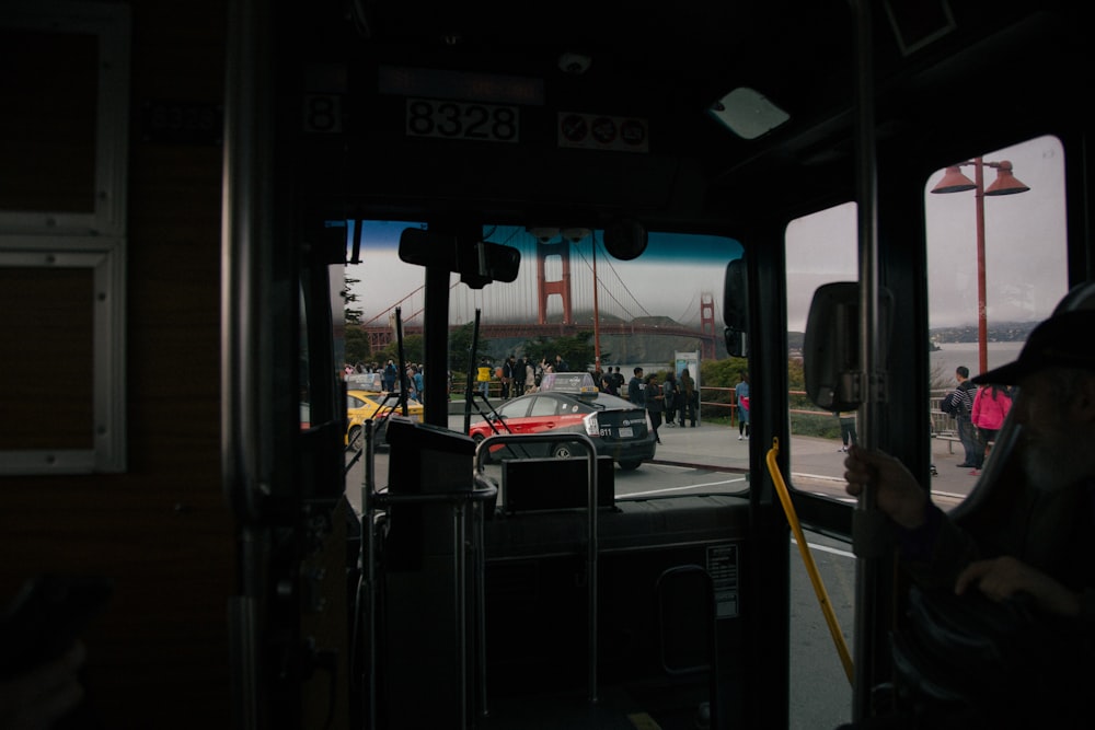 a bus driving down a street next to a bridge